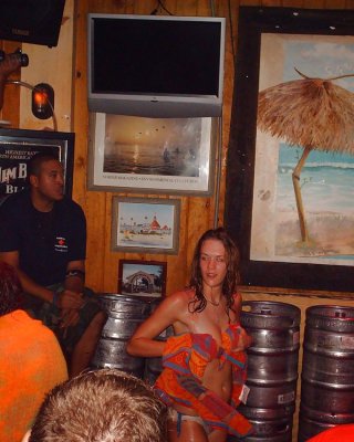 Two Topless Girls Play-fighting In A Bar