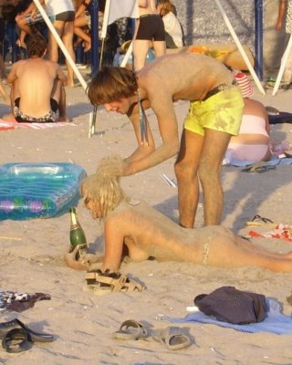 Young Nudist Friends Naked Together At The Beach