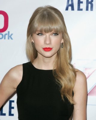 Taylor Swift Leggy Wearing A Black Mini Dress At Z100's Jingle Ball 2012 In NYC