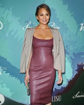 Chrissy Teigen busty wearing a low cut leather dress at the 2014 Variety Power o #75184134