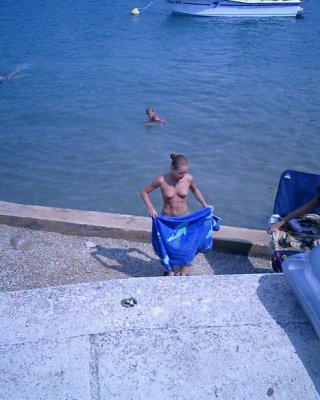 Barely Legal Nudist Babe Lights Up At The Beach