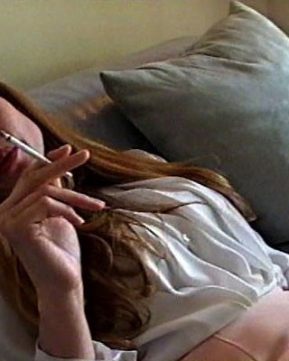 A Young Woman With Long Hair Bares Her Breasts, Utilizes A Vibrator, And Pensive