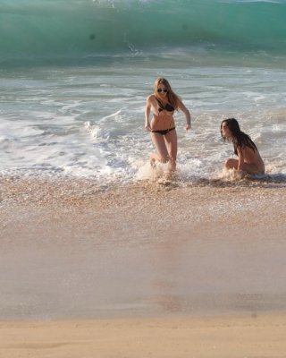 Two Hot Sexy Bikini Babes Flashing Their Racks On A Sandy Beach