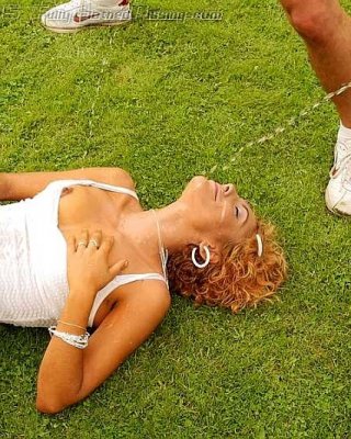 Two Guys Pissing Over A Redhead On An Outdoor Soccer Field