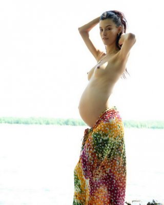 Pregnant Beauty Posing With Her Round Belly Outdoors