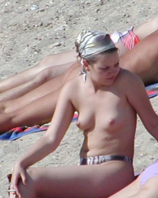 Unprintable Alluring curvaceous cutie strips at a nudist seaside