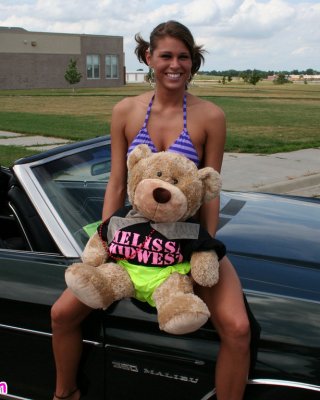 Melissa Midwest Posing On Cars At A Car Show