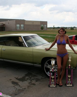 Melissa Midwest Posing On Cars At A Car Show