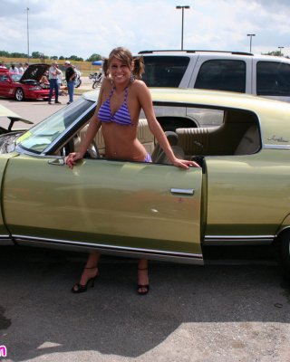 Melissa Midwest Posing On Cars At A Car Show