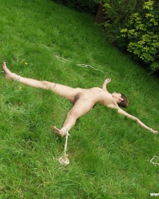 Asian Slave Staked Out In The Long Grass With Rope