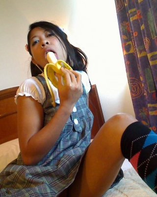 Asian Bali Teen Girl Blows Banana