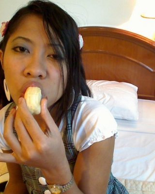 Asian Bali Teen Girl Blows Banana