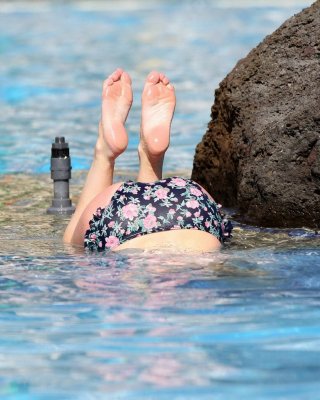 Jorgie Porter showing off her hot body in a skimpy floral bikini at the beach in #75172638