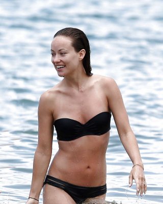 Olivia Wilde Showing Hot Body In Black Bikini On Beach