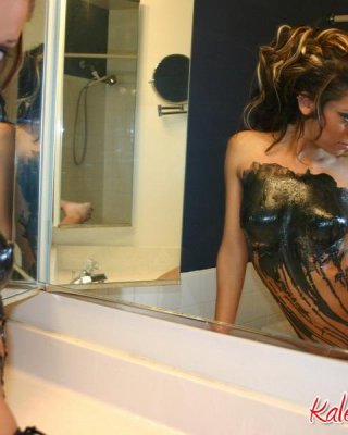 Kaley Kennedy Poses In Front Of The Mirror Covered In Black Latex